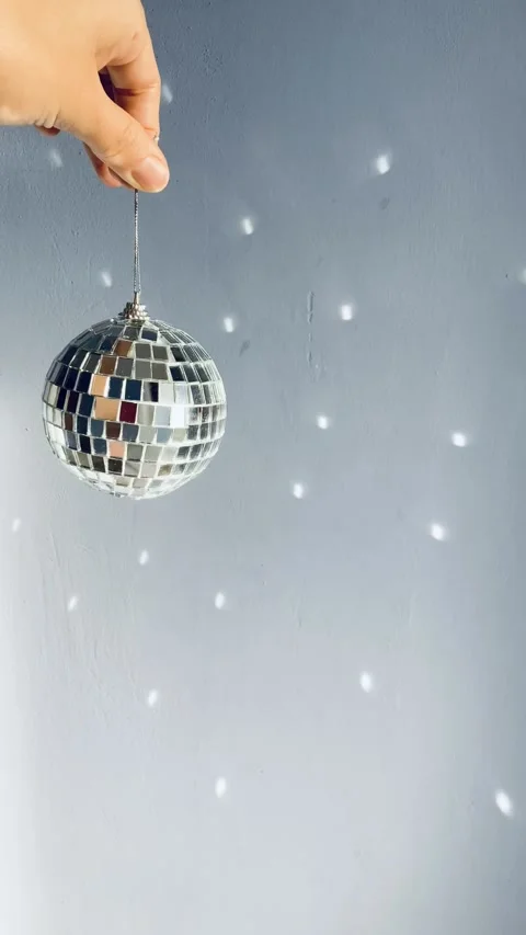 Discoball spinning in a hand Stock Footage 146897819