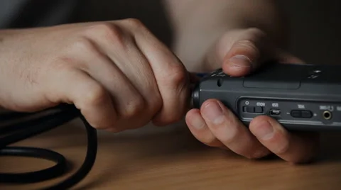 Disconnect the cable from the guy recording device Stock Footage 48935917
