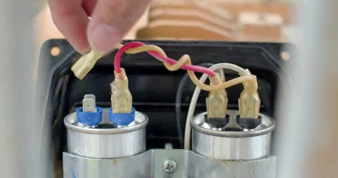 Disconnect the power cord to replace the capacitor. Stock Footage 307893080