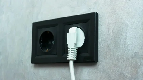 Disconnect from the power supply and remove the plug. Black wall socket Stock Footage 152930847