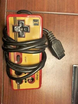 Disconnected famicom controller game over the table Stock Photos