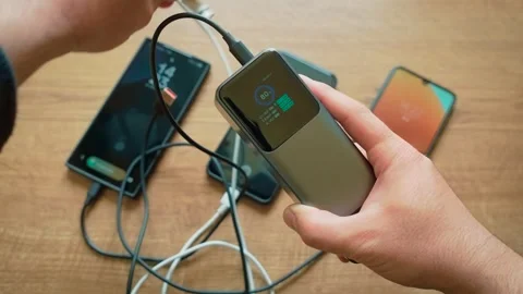 Disconnecting cables from power bank one by one stopping charge to multiple Stock Footage 333776996
