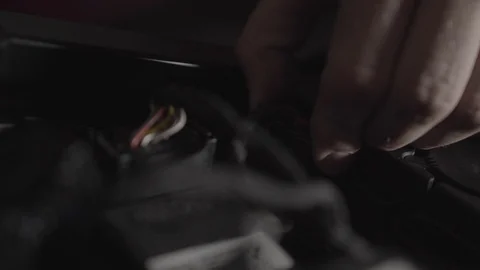 Disconnecting a connector from a motorcycle Stock Footage 125445887