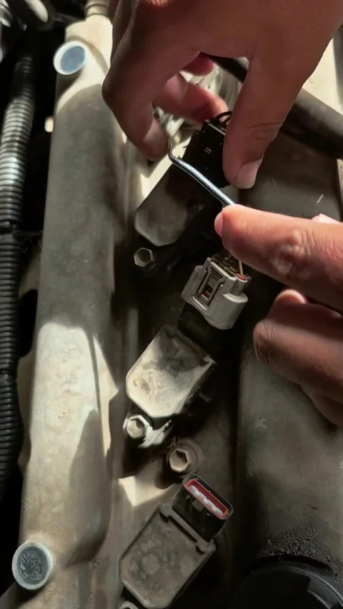 Disconnecting Ignition Coil Connectors During Engine Maintenance Video stock 335602746