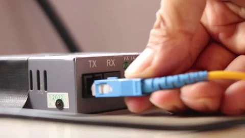 Disconnecting the internet network by unplugging the fiber optic cable connector Stock Footage 291595529
