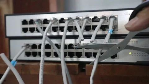 Disconnecting a network cable with scissors. 스톡 동영상 333871130