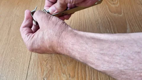 Disconnecting a Tension Spring from a Metal Hook by Hand Stock Footage 340541027