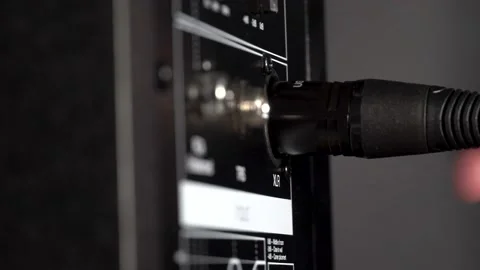 Disconnecting a XLR cable from speaker studio monitor Stock Footage 201991562