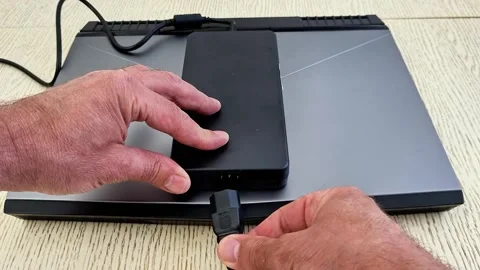 Disconnection an External SSD to a Laptop via USB Adapter Stock Footage 336708265