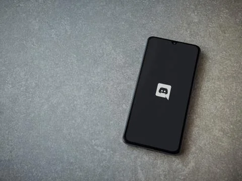 Discord app launch screen with logo on the display of a black mobile smartpho Stock Photos