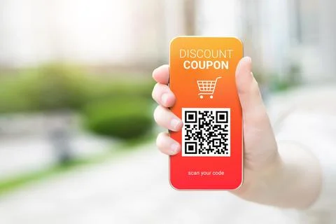 Discount coupon with QR code on smartphone in a female hand Stock Photos