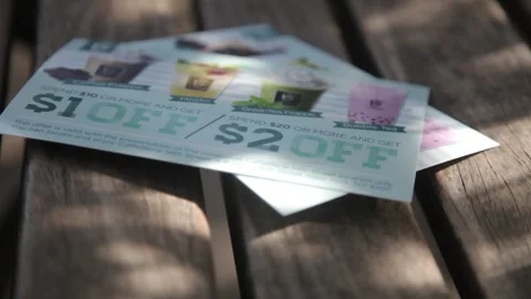 Discount coupons for drinks on a wooden table Stock Footage 341018959