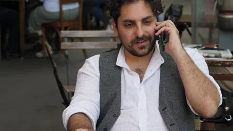 Discouraged depressed young man talking on the phone while drinking whiskey Stock Footage 240337813