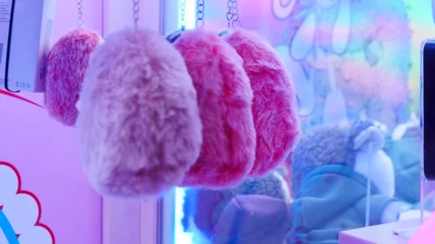 Discover Adorable Plush Hedgehogs Available in a Colorful Claw Machine for Stock Footage 310537155