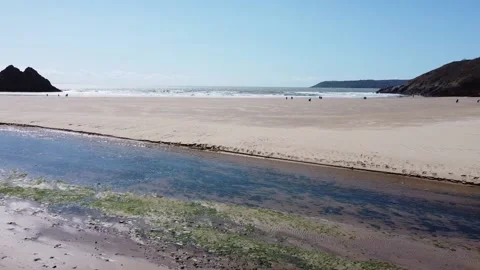 Discover the Breathtaking Beauty of Three Cliffs Bay: Wales' Coastal Gem wit.. Stock Footage 239990744