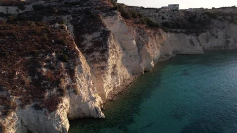 Discover the breathtaking cliffs and azure waters of Crete, Greece at sunset Stock Footage 283769573