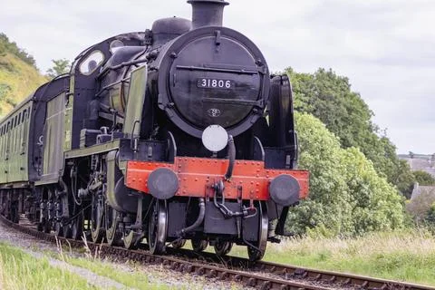 Discover a captivating steam engine moving along a scenic railway track Stock Photos