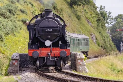 Discover a captivating steam engine moving along a scenic railway track Stock Photos