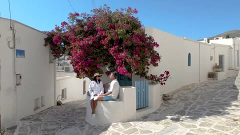 Discover charming streets adorned with vibrant flowers in Paros, Greece Stock Footage 336530711