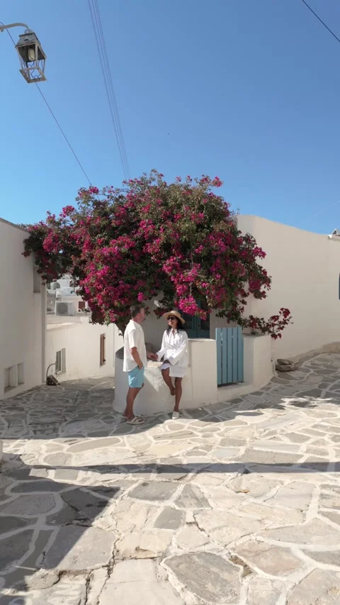 Discover the charming streets of Paros, Greece filled with vibrant bougainvillea Stock Footage 337361149