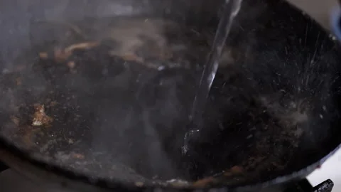 Discover Effective Methods for Cleaning an Oily Pan Using Water and Simple Stock Footage 312014636