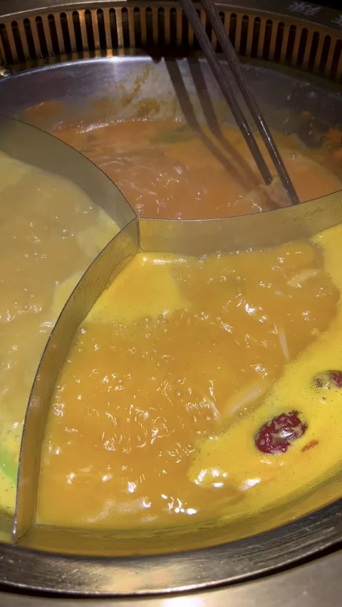Discover Hot Pot Preparation With Different Flavors and Ingredients at a Stock Footage 329244805
