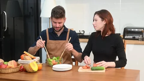 Discover a joyful couple preparing fresh vegetables, embracing healthy eati.. Stock Footage 312981007