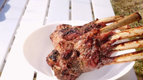 Discover roasted meat on bone displayed on table. The meat brings out the Stock Footage 276463231