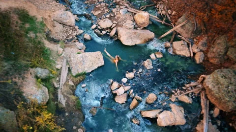Discover the tranquility of a natural hot spring pool in autumn Stock Footage 310217213