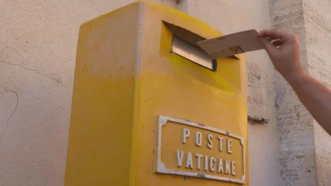 Discover the vibrant yellow mailbox at this charming Vatican street corner Stock Footage 284560891