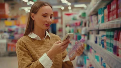Discovering the Benefits of Micellar Water While Shopping in a Skincare Aisle 스톡 동영상 293673721