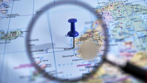 Discovering Bergen through a map and magnifying glass for travel plans Stock Photos