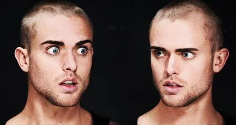 Discovering a different side of himself. A psychotic young man looking surprised 写真素材