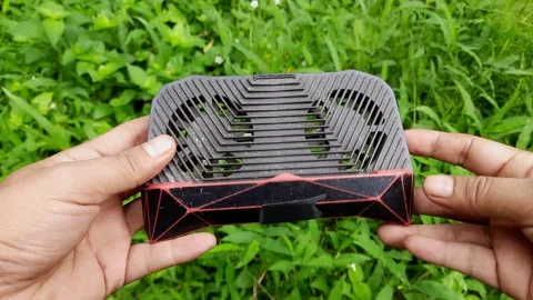 Discovering an Innovative Cooling Device in a Lush Green Environment Stock Footage 295671371