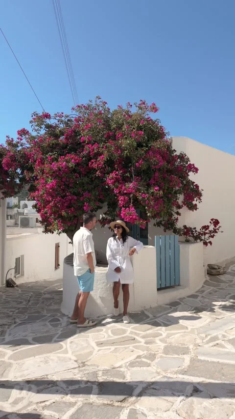 Discovering Paros Greece under the vibrant bougainvillea Stock Footage 337358515