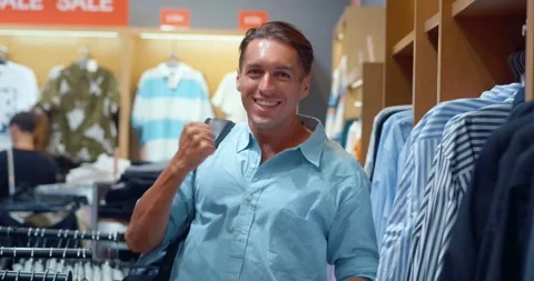 Discovering perfect piece man experiences pure joy of purchase in men's store Stock Footage 259841405