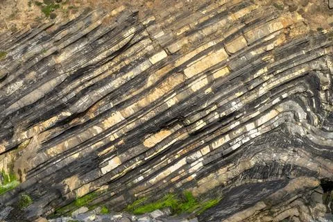 Discovering Striking Geological Patterns in Unique Layered Rock Formations that Stock Photos