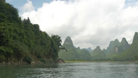Discovering sugarloafs with forests from a river on a boat, in China Stock Footage 232176638