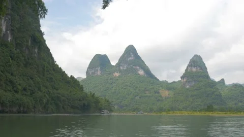 Discovering sugarloafs with forests from a river on a boat, in China Stock Footage 232178159