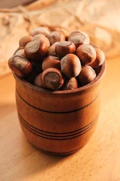 Discovering the warmth of rustic kitchen with natural hazelnuts in a wooden bowl Stock Photos