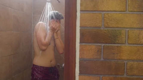 Discovery shot of different people taking warm baths in adjacent showers at a Video stock 119801614