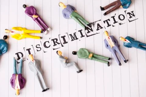 Discrimination text on white paper with disabled people around Stock Photos