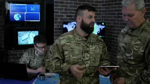 Discussing battle strategy and looking at digital tablet, security Stock Footage