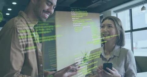 Discussing code on glass partition in office, two developers gesturing with Stockfoto's