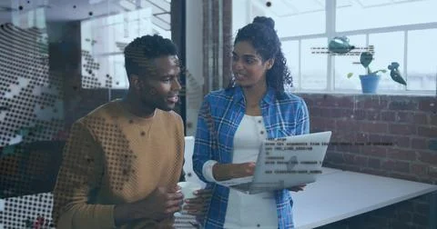 Discussing code snippets while software developers viewing laptop at brick of Stock Photos