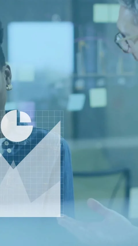 Discussing data analytics, business professionals in office with graphs and Stock Footage 344244759