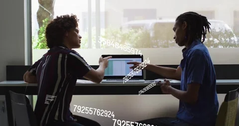 Discussing data with floating numbers, two people using laptop in school setting Stock Footage 326191044