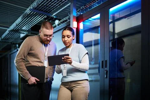 Discussing Data Security Strategies in Server Room Stock Photos