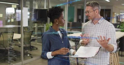 Discussing developer in denim and manager in plaid shirt at office with Stock Photos