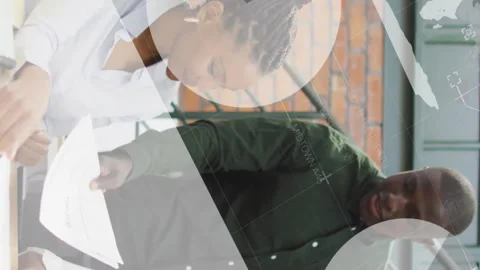 Discussing documents, diverse team in office with data processing animation Stock Footage 313356310